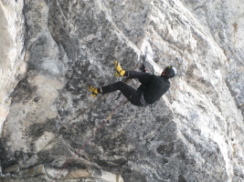 climber on a mixed route behind The Fang