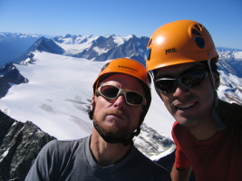 two happy climbers on the summit