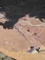 Cranking on the A0 pitch, Dow belaying me