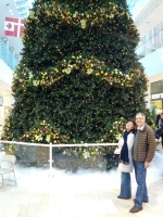 Parents in front of giant Xmas tree