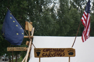 Chainsaw carvings and gold panning! And that's the Alaska flag, not EU :)